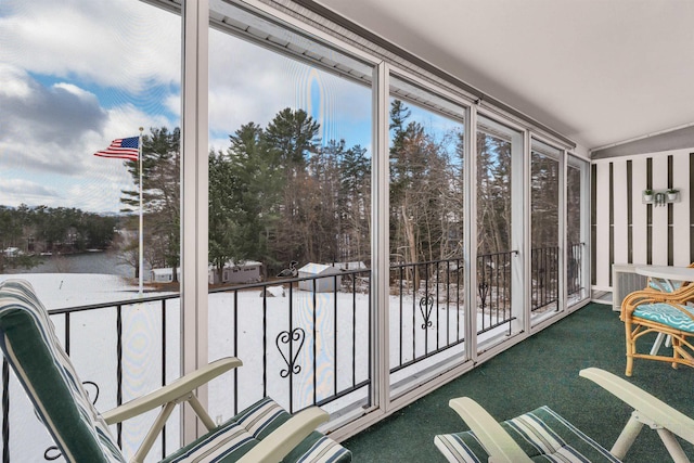 unfurnished sunroom with lofted ceiling