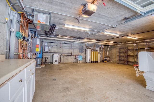 garage with a garage door opener, electric panel, and gas water heater