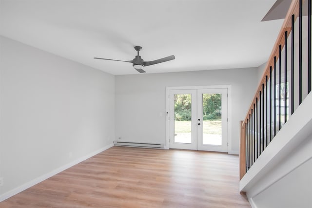 spare room featuring a baseboard heating unit, french doors, ceiling fan, and light hardwood / wood-style floors