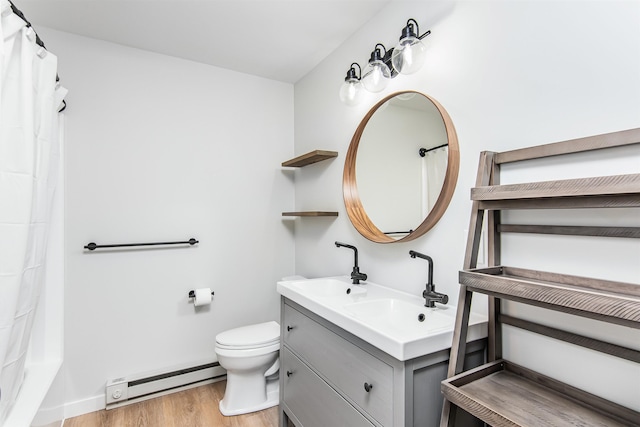 bathroom featuring baseboard heating, vanity, toilet, and hardwood / wood-style floors