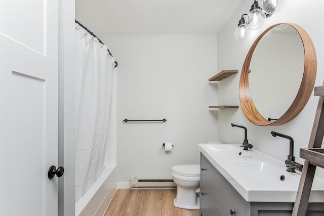 full bathroom featuring shower / bathtub combination with curtain, a baseboard heating unit, toilet, wood-type flooring, and vanity