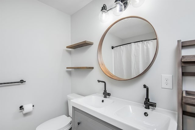 bathroom featuring vanity and toilet