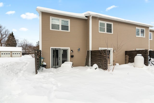 view of snow covered rear of property