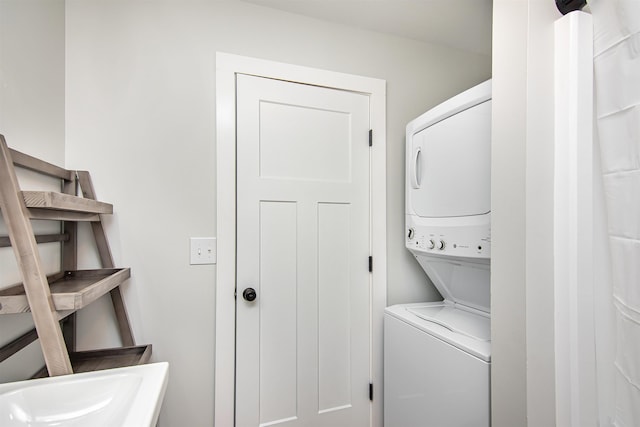 washroom featuring stacked washer / dryer