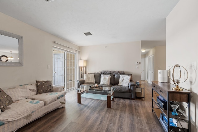 living room with dark hardwood / wood-style flooring and a textured ceiling