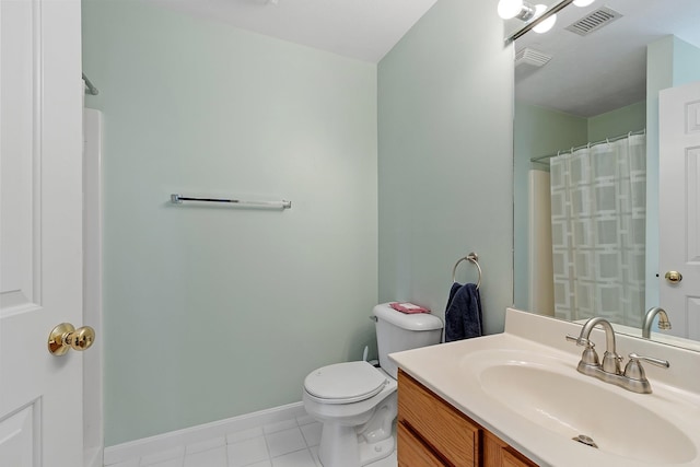 bathroom featuring tile patterned floors, vanity, toilet, and walk in shower