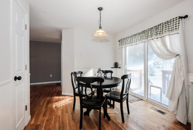 dining room with dark hardwood / wood-style flooring