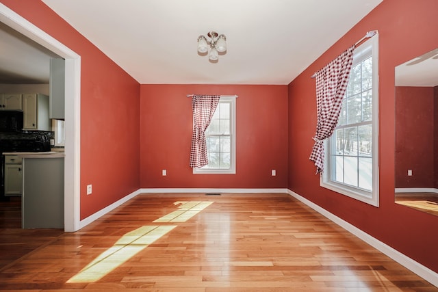 unfurnished dining area featuring a healthy amount of sunlight and light hardwood / wood-style flooring