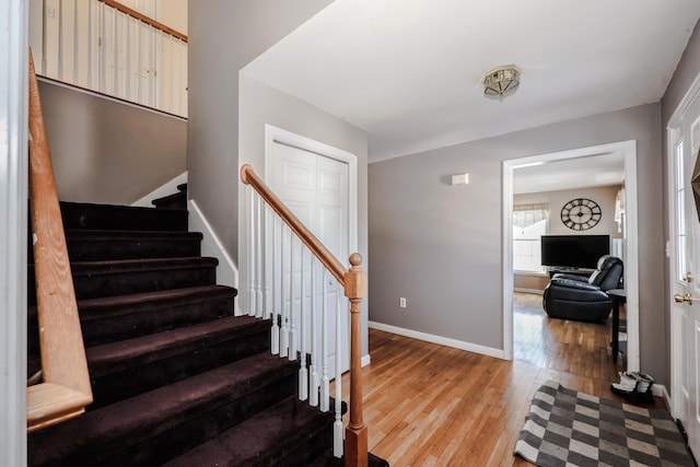 stairs with hardwood / wood-style floors