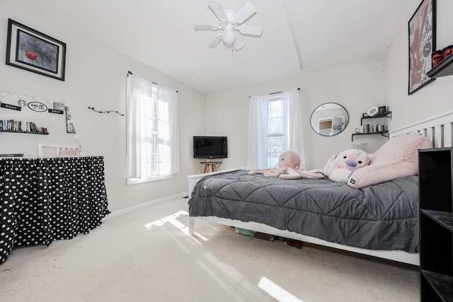 bedroom featuring ceiling fan, carpet floors, and multiple windows