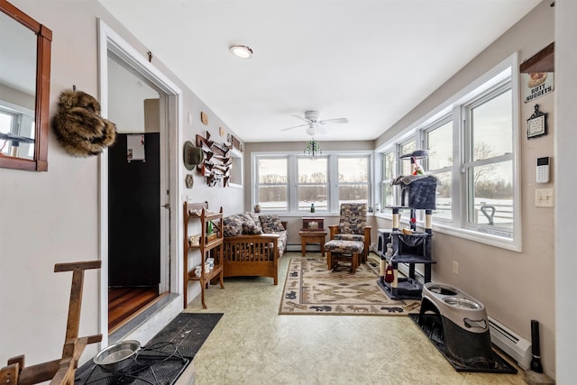 sunroom / solarium featuring ceiling fan and a baseboard radiator