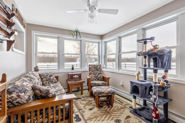 sunroom with ceiling fan and a baseboard radiator