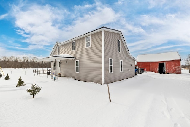 view of snow covered back of property