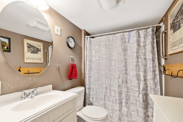 bathroom featuring toilet, vanity, and a shower with curtain