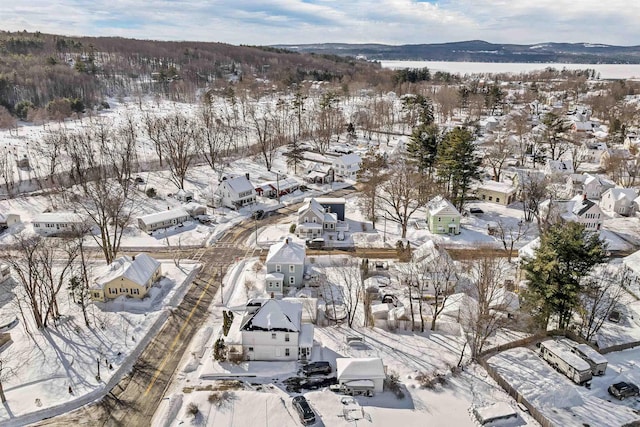 snowy aerial view with a mountain view