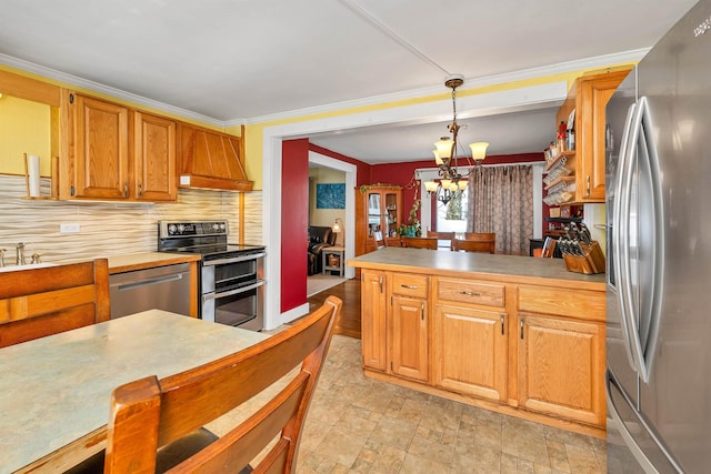 kitchen with appliances with stainless steel finishes, decorative light fixtures, decorative backsplash, crown molding, and custom exhaust hood