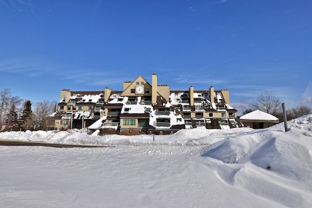 view of snow covered back of property