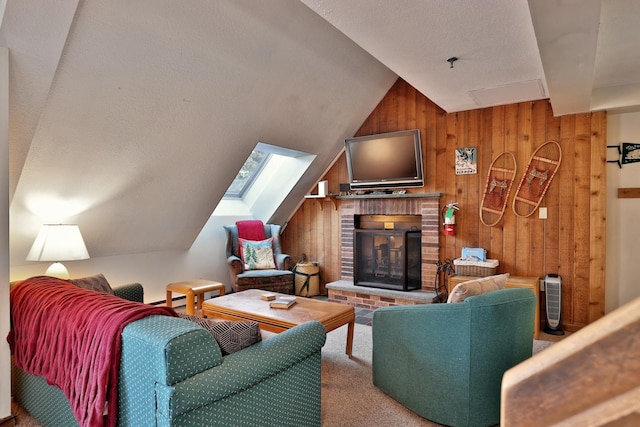 carpeted living room featuring vaulted ceiling, wood walls, and a fireplace