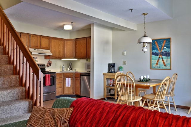 kitchen featuring appliances with stainless steel finishes and decorative light fixtures