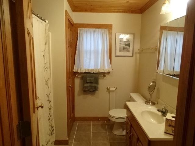 full bathroom featuring toilet, vanity, baseboards, ornamental molding, and tile patterned floors