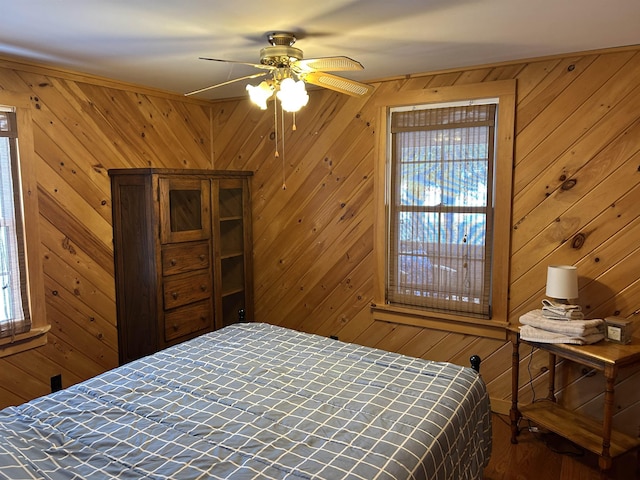 bedroom featuring wood walls and wood finished floors