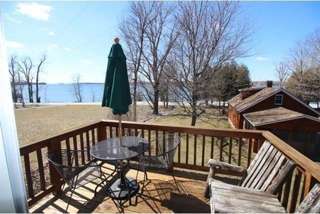 wooden deck featuring a water view