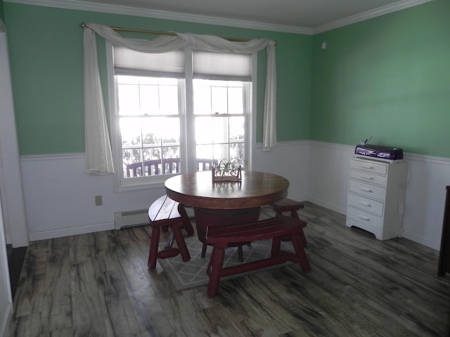 dining space featuring crown molding, a baseboard heating unit, and dark hardwood / wood-style floors