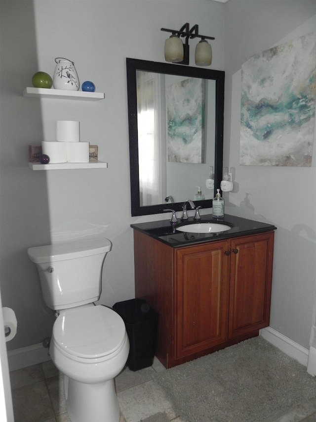 bathroom featuring toilet and vanity