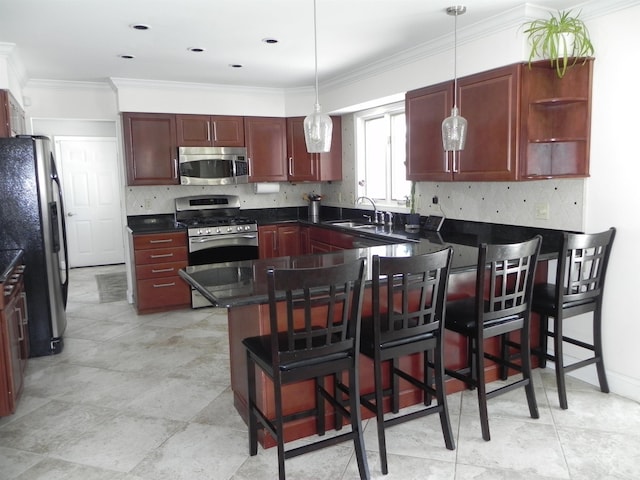 kitchen featuring a peninsula, a sink, appliances with stainless steel finishes, dark countertops, and backsplash