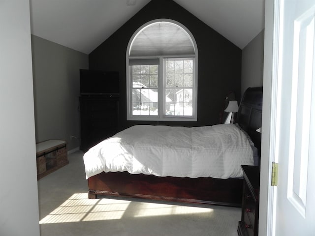 carpeted bedroom featuring lofted ceiling