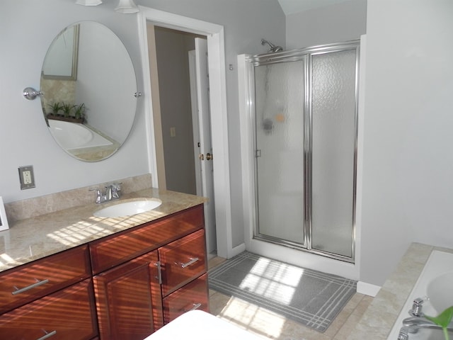 bathroom featuring tile patterned flooring, vanity, and plus walk in shower