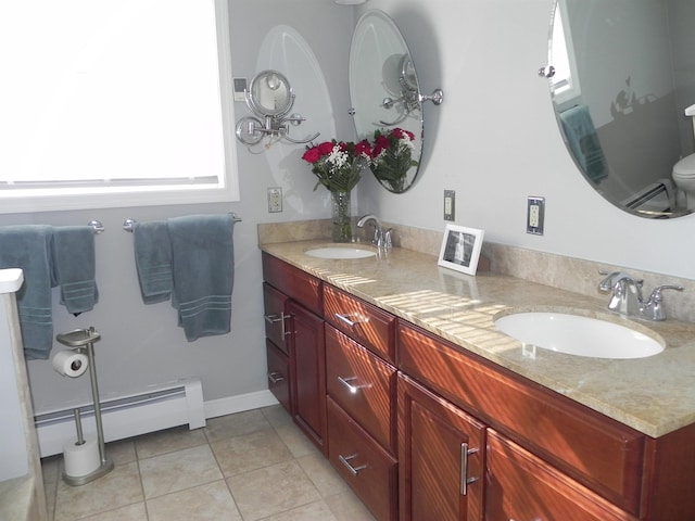 bathroom featuring tile patterned floors, a baseboard heating unit, toilet, and vanity