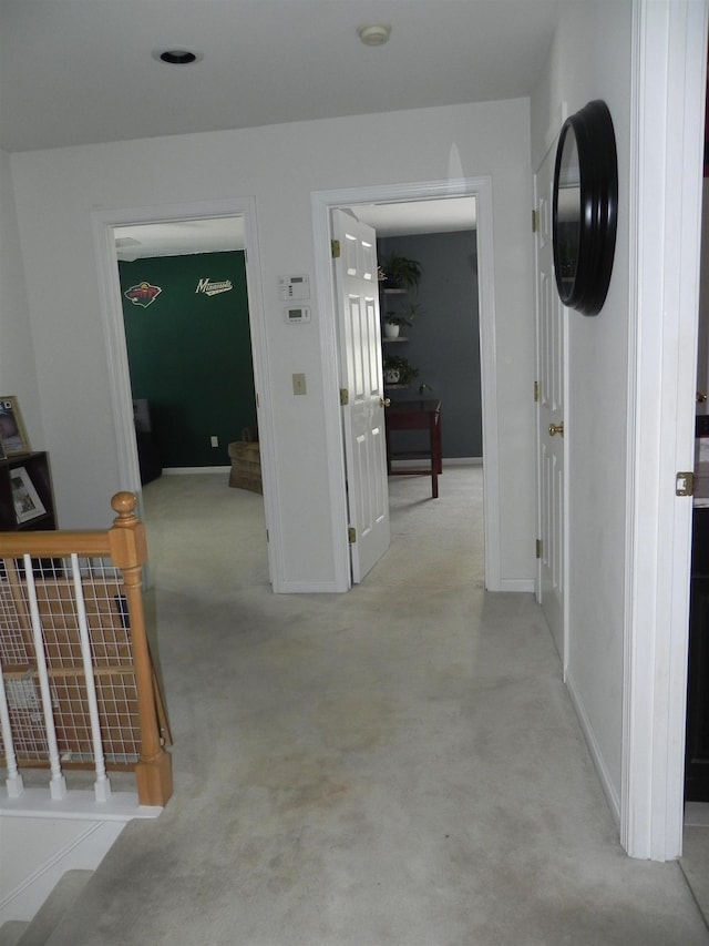 hallway featuring light carpet