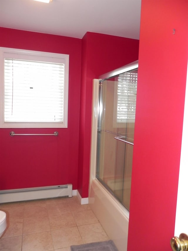 bathroom featuring tile patterned floors, combined bath / shower with glass door, toilet, and a baseboard radiator