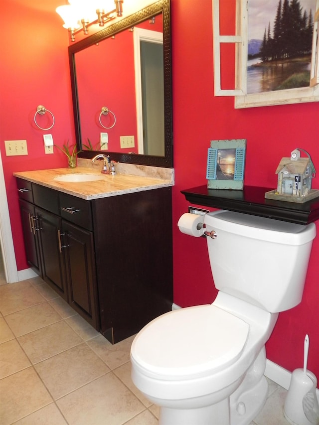 bathroom featuring toilet, tile patterned flooring, and vanity