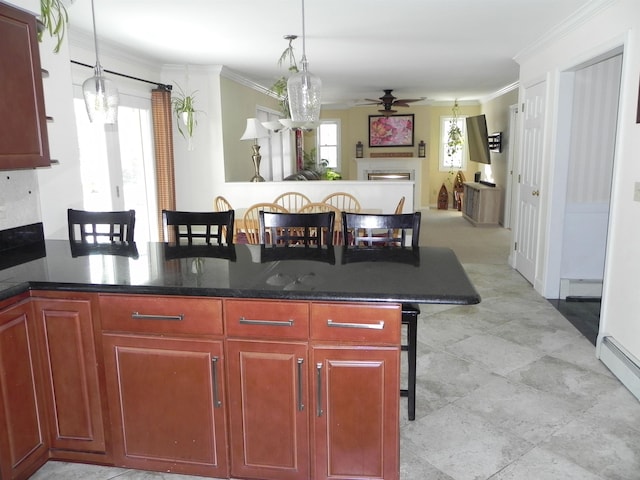 kitchen featuring a baseboard radiator, crown molding, a kitchen breakfast bar, and decorative light fixtures