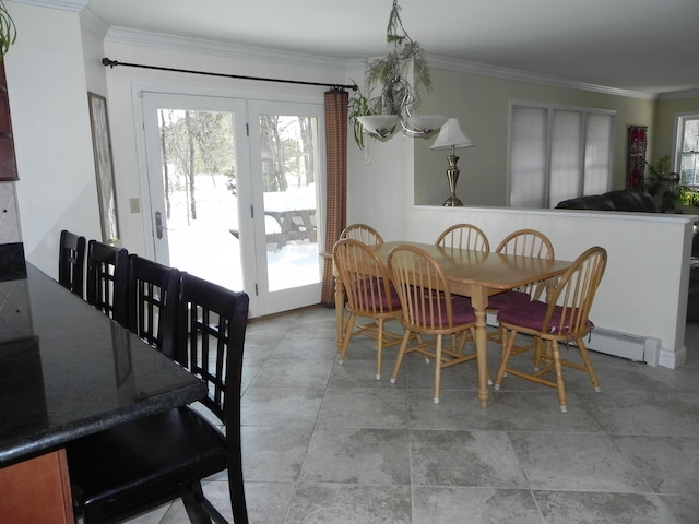 dining space featuring crown molding and a baseboard heating unit