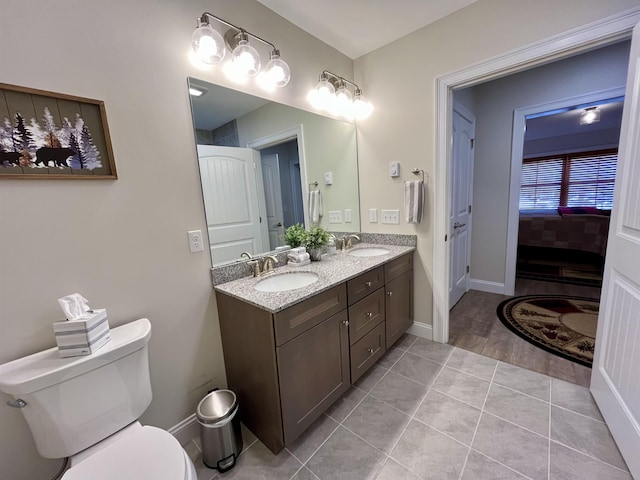 bathroom featuring vanity, tile patterned flooring, and toilet