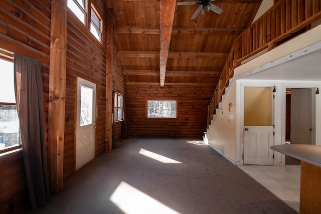 interior space with plenty of natural light, wooden ceiling, high vaulted ceiling, and beamed ceiling