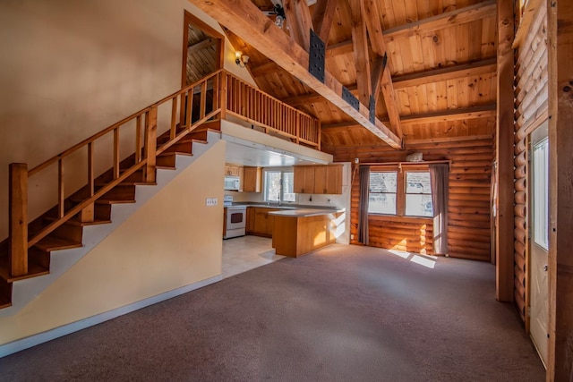 kitchen featuring light colored carpet, white appliances, high vaulted ceiling, and kitchen peninsula