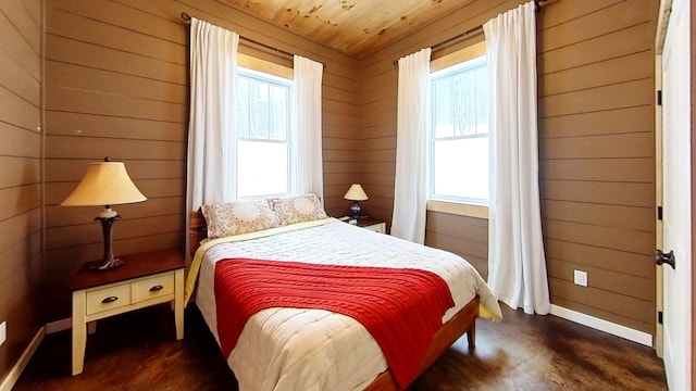 bedroom featuring wooden ceiling and wood walls