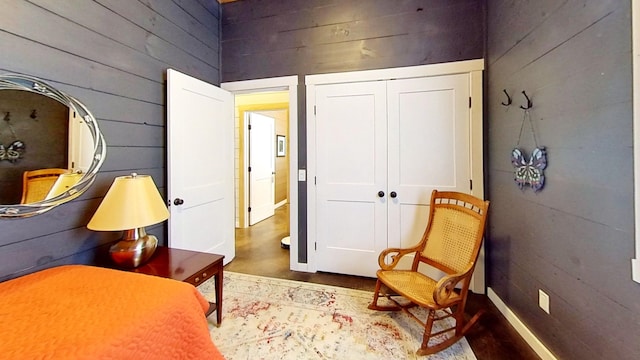 sitting room featuring wooden walls