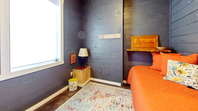 bedroom with wood walls