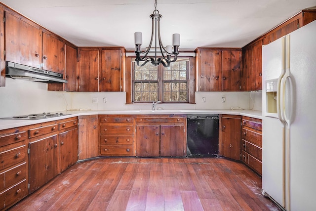 kitchen with white refrigerator with ice dispenser, hanging light fixtures, dishwasher, stainless steel gas stovetop, and sink