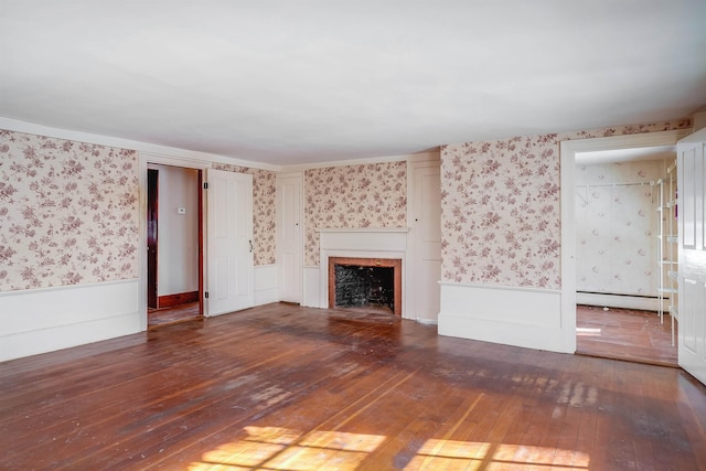 unfurnished living room with dark hardwood / wood-style flooring and baseboard heating