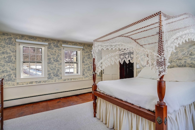 bedroom featuring wood-type flooring and a baseboard radiator