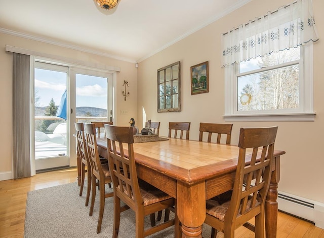 2400 Upper Cold River Rd, Shrewsbury, VT 05738 - dining room featuring light hardwood / wood-style flooring, ornamental molding, and a baseboard radiator