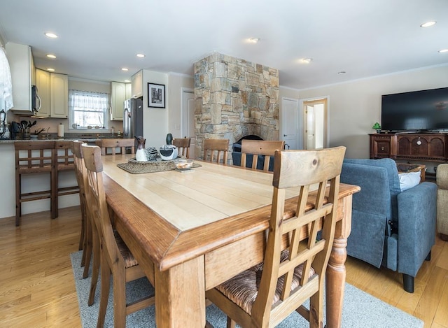 2400 Upper Cold River Rd, Shrewsbury, VT 05738 - dining room featuring light hardwood / wood-style flooring, a stone fireplace, and crown molding