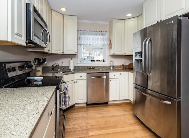 2400 Upper Cold River Rd, Shrewsbury, VT 05738 - kitchen with appliances with stainless steel finishes, light wood-type flooring, crown molding, sink, and white cabinetry