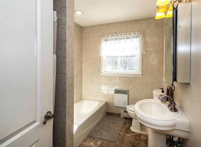2400 Upper Cold River Rd, Shrewsbury, VT 05738 - bathroom featuring tile walls, a tub to relax in, radiator heating unit, toilet, and baseboard heating